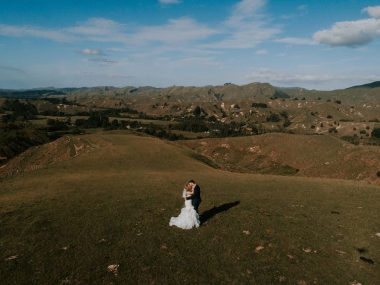 A couple kiss for a New Zealand farm wedding photography by Binh Trinh