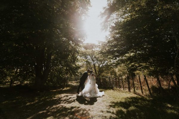 Bridal portrait of bride and groom walking on a farm wedding photoshoot