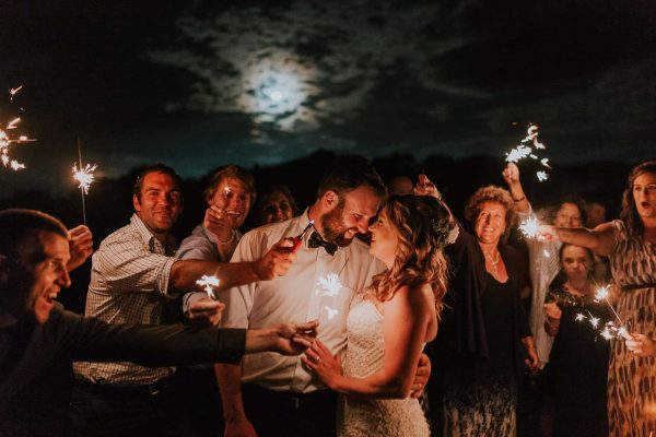 A creative bride and groom wedding photo with sparkles at a New Zealand farm wedding